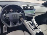 the interior of a car with a steering wheel and dashboard controls