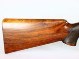 a close up of a rifle on a white surface with a white background
