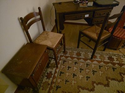 une photo d'une pièce avec un bureau, une chaise et un ordinateur
