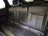 the back seats of a car are black with red buttons