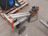 a machine that is sitting on the ground next to a pallet