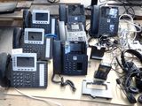 a lot of telephones that are sitting on a table