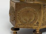 a gold statue of a boy on a box