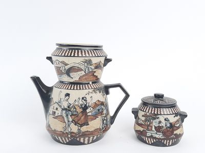 two pieces of pottery that are sitting on a table