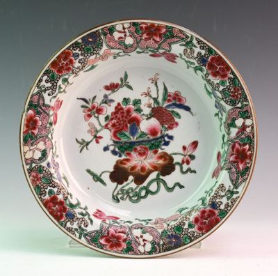 a plate with a bird and flowers on it
