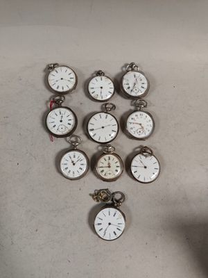 a lot of pocket watches sitting on a table