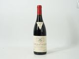 the bottle of wine is sitting on a white surface