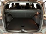 the back of a car with the trunk open and the seats folded down