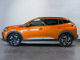 the orange suv is parked in a room with a white wall