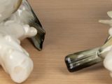 two figurines that are sitting on a table