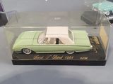 a green and white model car in a clear box
