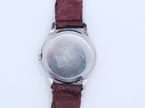 a close up of a wrist watch on a white surface
