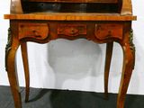 a wooden desk with a drawer on top of it
