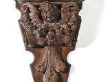 a close up of a wooden wall mounted on a white wall