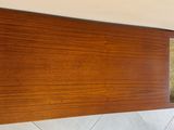 a wooden shelf with a glass window on it