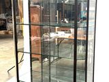 a glass display case with a clock inside of it