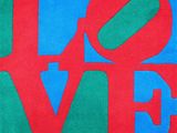 a close up of a red and green love sign on a blue background