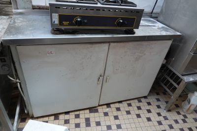 an image of a kitchen with a stove and a cabinet