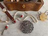 a wooden box filled with assorted jewelry on a table