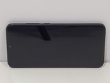 the back of a black cell phone sitting on top of a white surface
