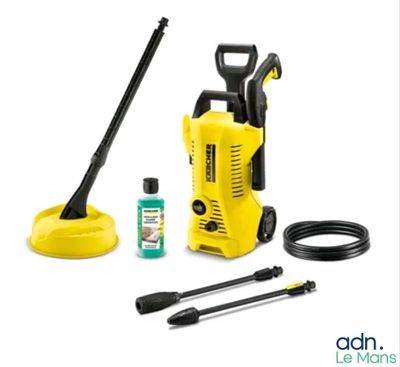 a yellow pressurer with a hose and other cleaning supplies