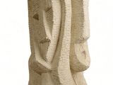 sculpture of a woman ' s face made of straw on a white background