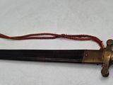 an old dagger is laying on a white surface