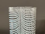 a close up of a glass vase with a wavy design on it