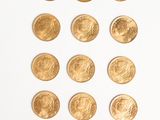 a lot of gold coins on a white surface