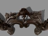 a picture of a pair of wooden carvings on a wall