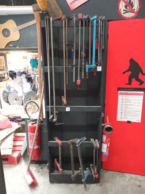 a red door in a garage with tools on it