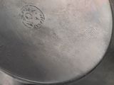 a silver pot with a handle on a table