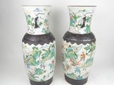 two vases that are sitting on a white surface