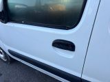 a white van parked in a parking lot with its door open