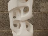 a white sculpture sitting on top of a white pedestal