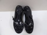 pair of black shoes on a white surface with a white background