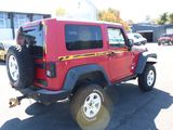a red jeep that is parked in a parking lot