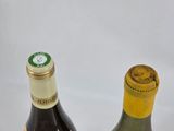 two bottles of wine sitting next to each other on a table