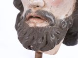 a statue of a man with a beard on a stick
