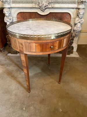 a marble top table in front of a fireplace