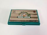 an image of a green house card case sitting on top of a white table