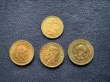 three gold sovereigns, one of which is a sovereign and one of which is a sovereign