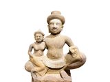 an image of a statue of a man and a child sitting on a rock