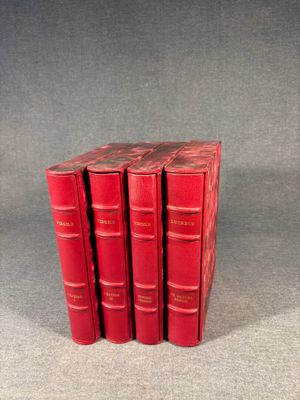 four red books stacked on top of each other on a gray surface