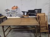 several chairs and a table in a room with a lot of clutter