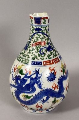 a blue and white vase with a dragon on it