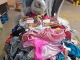 a pile of clothing on a table in a warehouse
