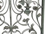 a metal gate with flowers and leaves on it