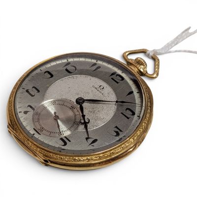 a gold pocket watch with a white string around it