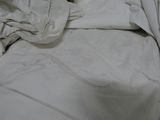 an image of a bed with white sheets and pillows